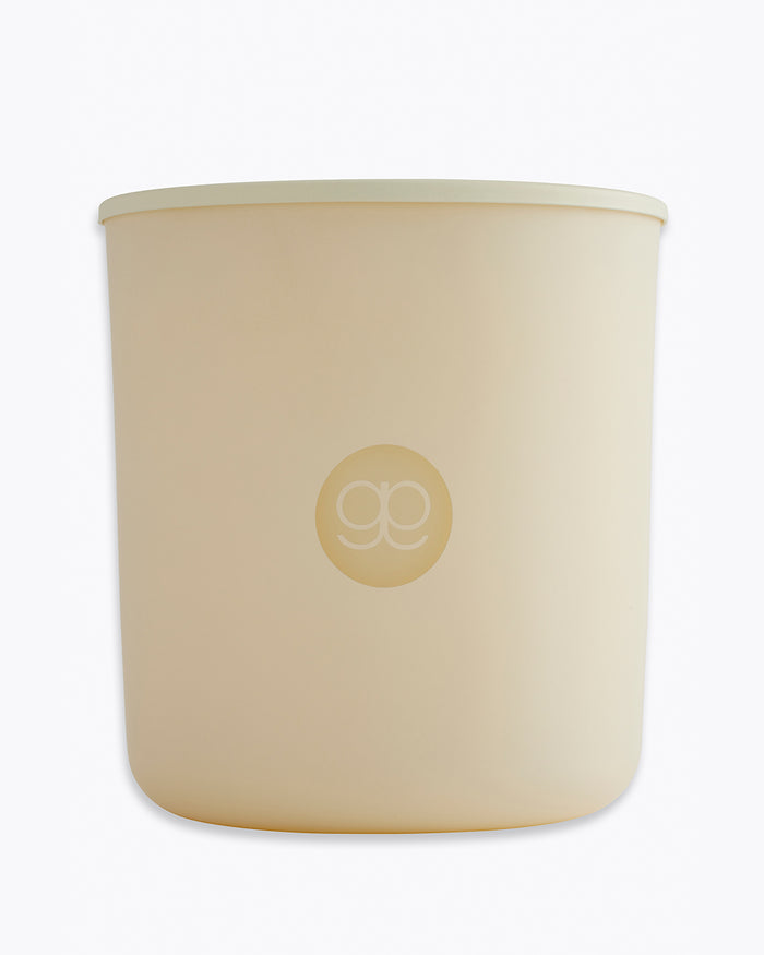 Beige candle with a logo on a white background