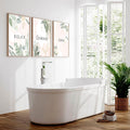 Modern bathroom with three framed botanical wall art prints featuring relax, unwind and soak text
