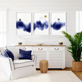 A set of three framed nautical wall art prints featuring abstract blue waves, a sailboat, and palm trees