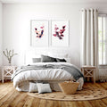 Scandinavian bedroom featuring a wall art for bedroom set of 2 with pink botanical prints above a white bed